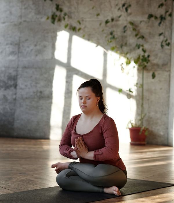 Person doing peaceful morning yoga in a sunlit room